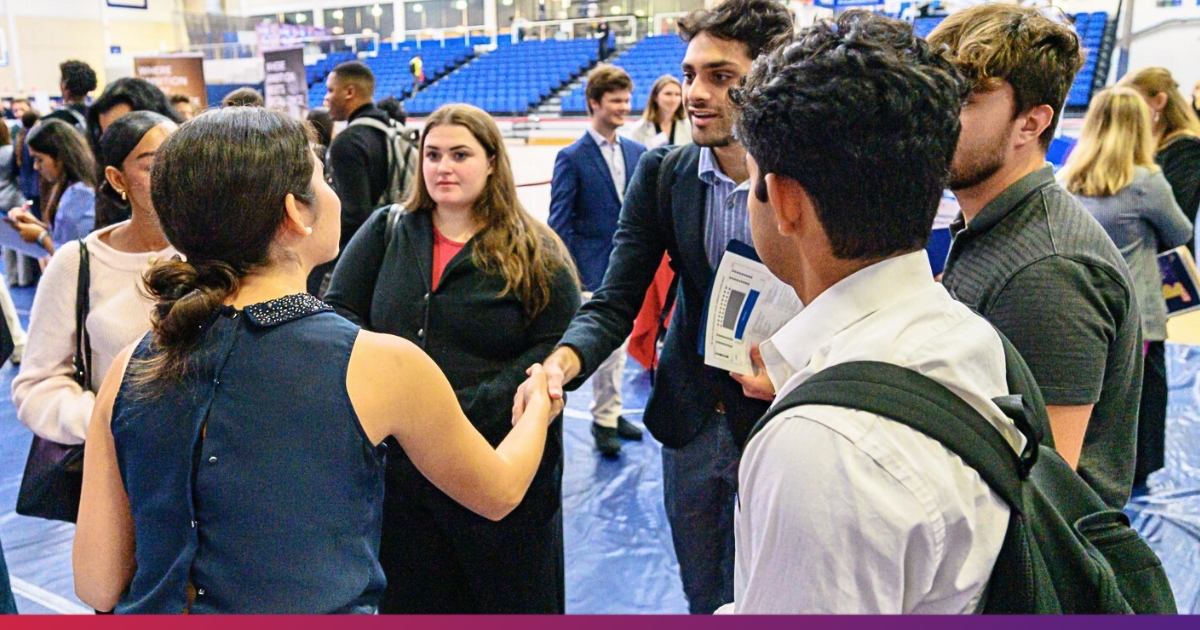 Students Shaking Hands with Employer During Career and Internship Fair at American University