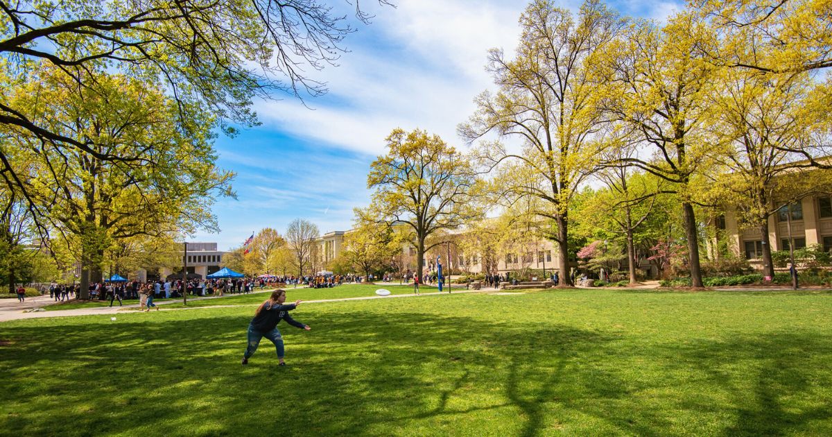 Student Playing Frisbee on American University Quad