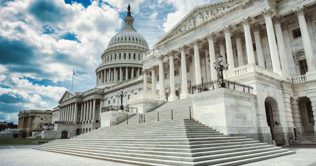 Exterior of the United States Capitol building with a cloudy sky