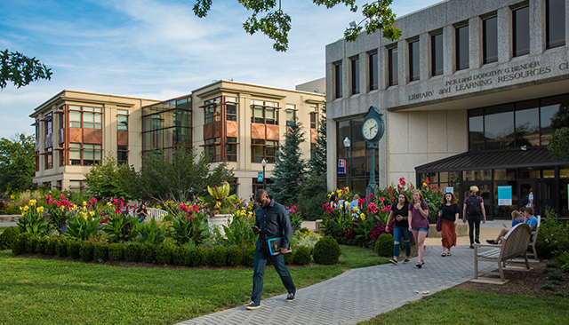 Students walking in front of SIS building and Bender Library