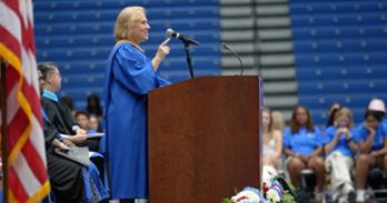 Patty Caballero points at the crowd of new students during her Convocation remarks.