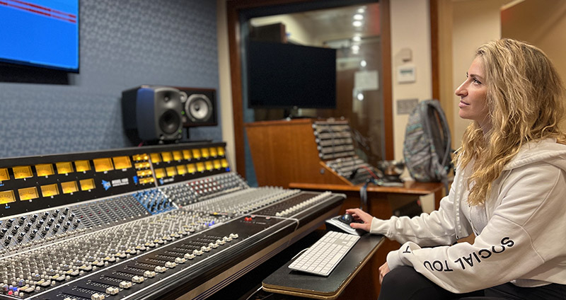 Audio Technology student Tessa working at the control board.