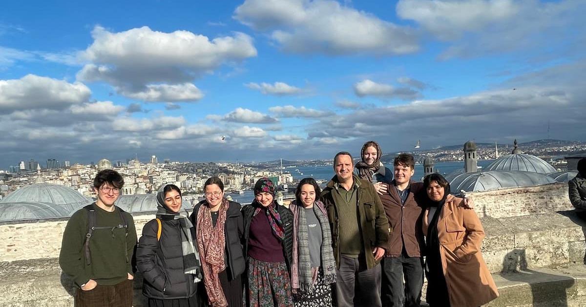 Rooftop photo of the tour group with Istanbul laid out behind them.