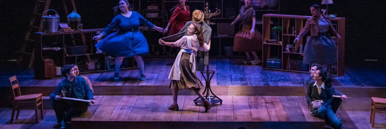 Woman dances with man's jacket hanging on a coatrack