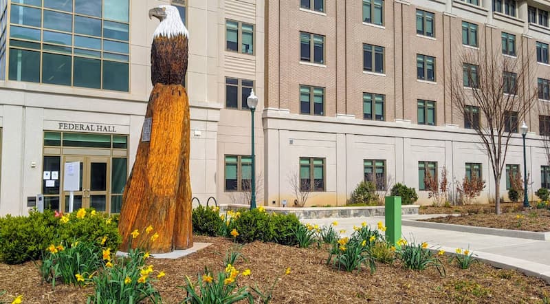 Federal Hall entrance on American University East Campus with eagle statue.