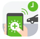 Phone in hand with car in background.