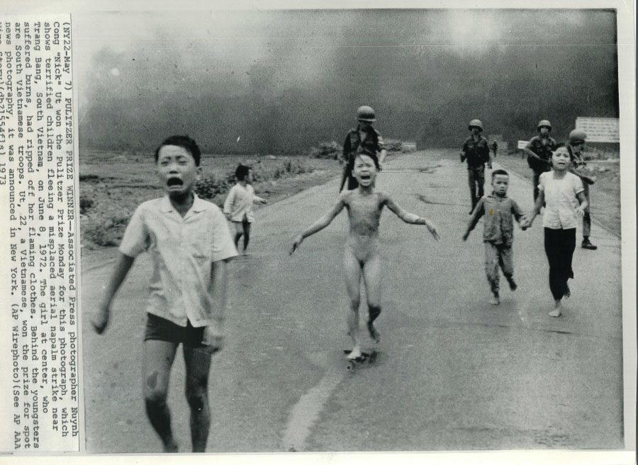 Children running down a road, crying, followed by soldiers. Eddie Adams, photographer.