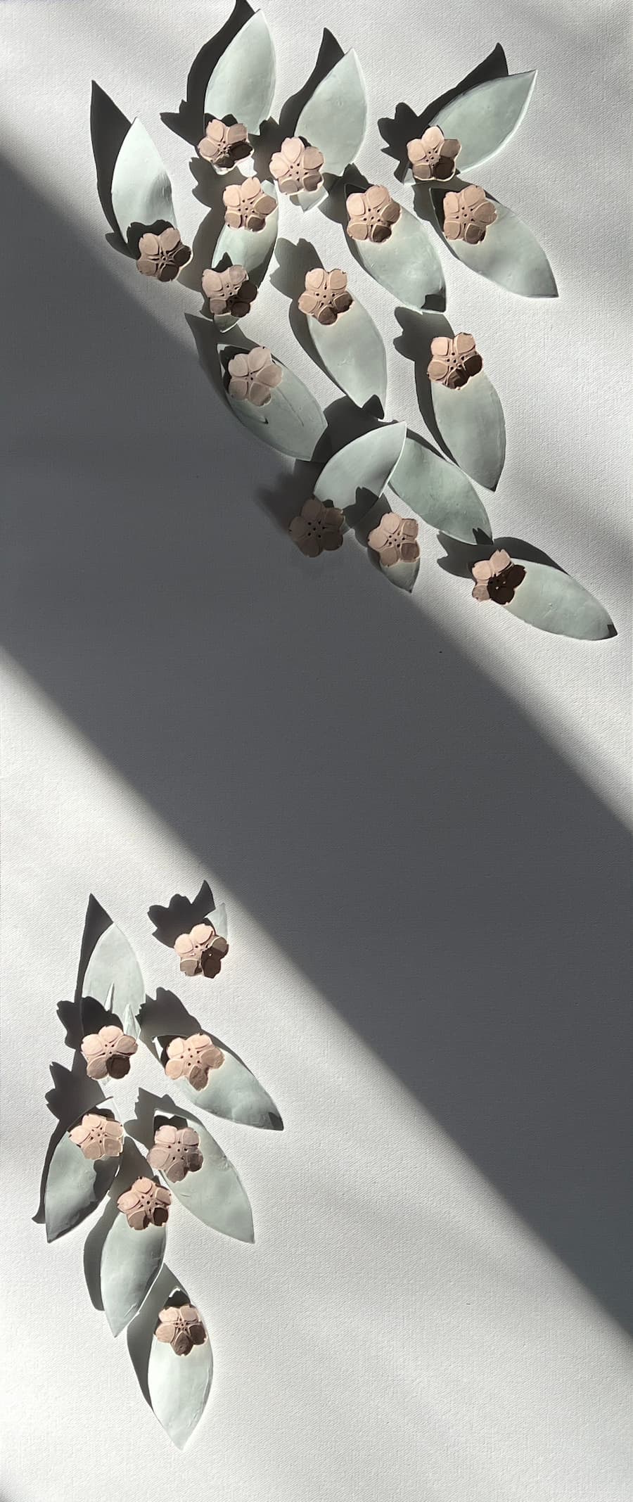 Julia Zhang, Spring, 2025. Ceramic leaves and blossoms.
