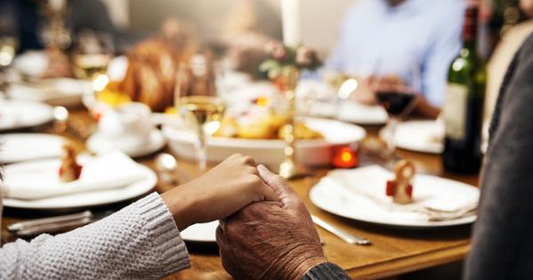 Holding hands at dinner table