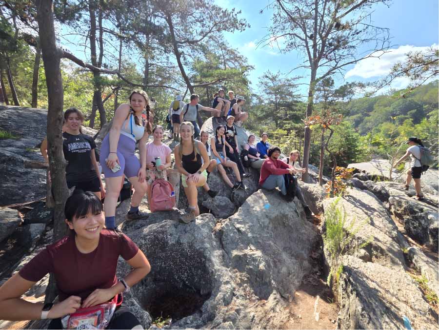 Students sitting on rocks at Great Falls