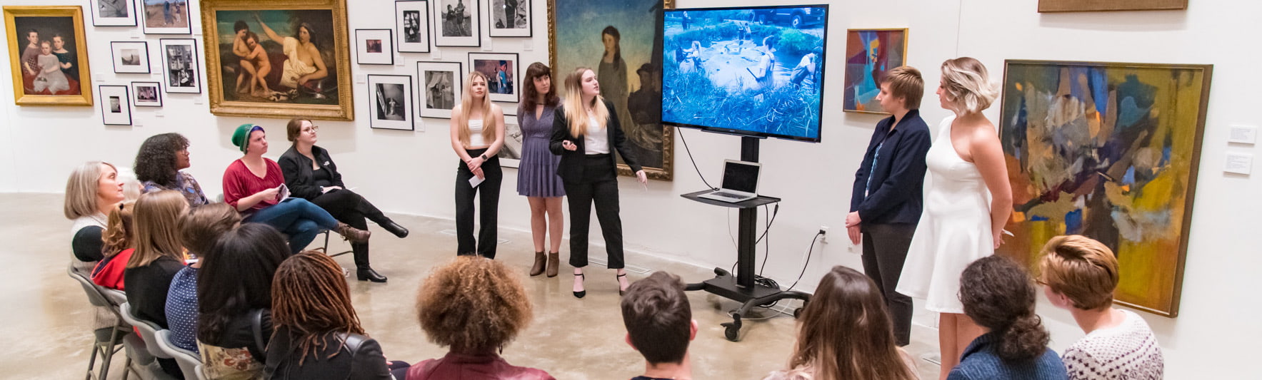 Dancers discuss sustainability practices with an audience in the American University Museum