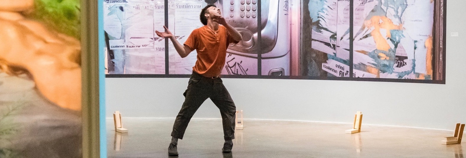 Dancer performs in the American University Museum surrounded by large scale photography