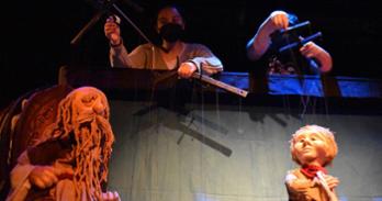Performers controlling puppets