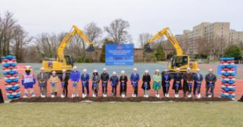 Community members gathered outside with shovels for ceremonial groundbreaking of the new Meltzer Center