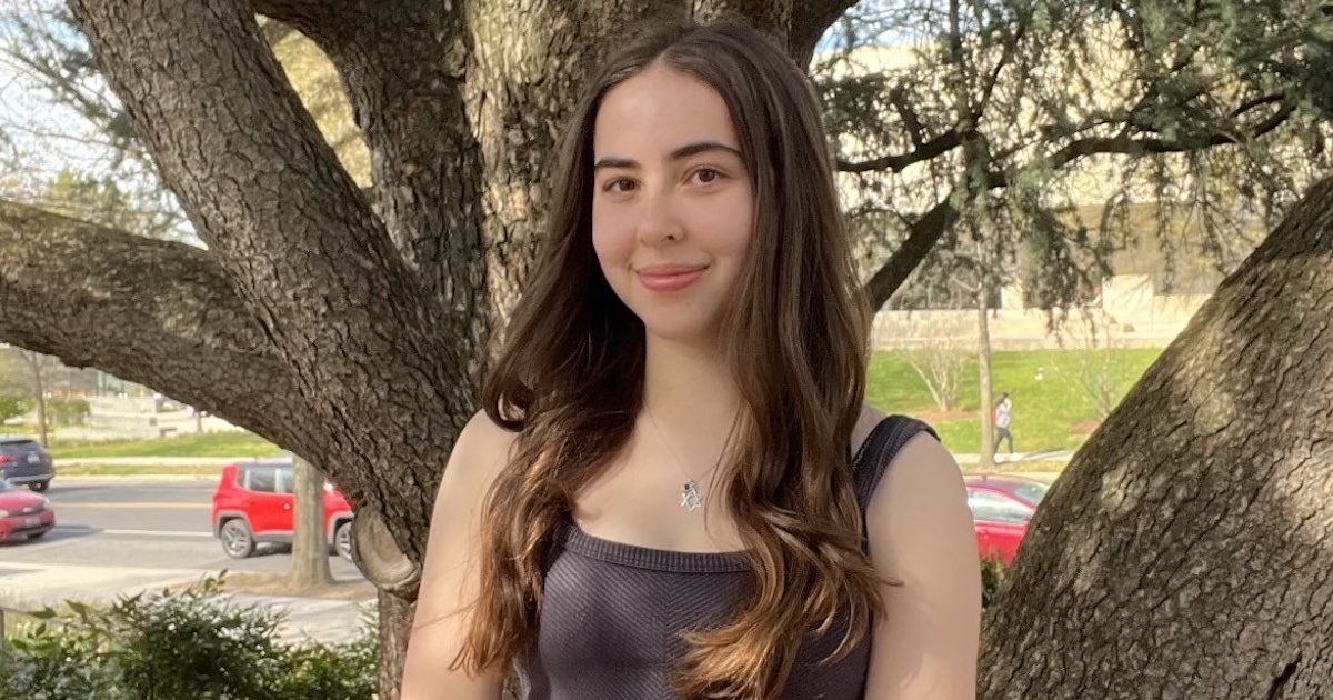 Chloe Leeds sitting outside on AU's campus