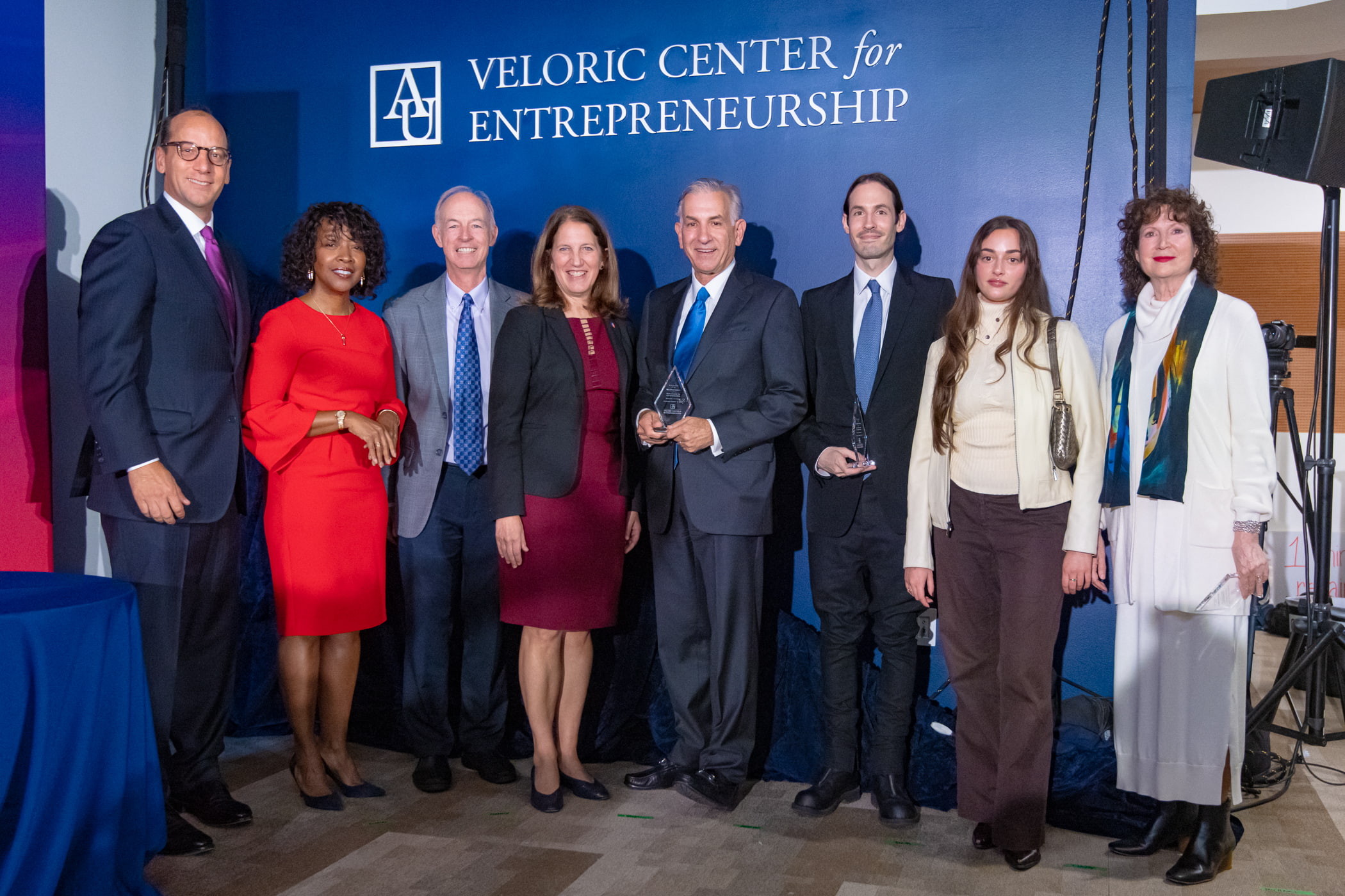 Leadership in front of Veloric Center lettering.