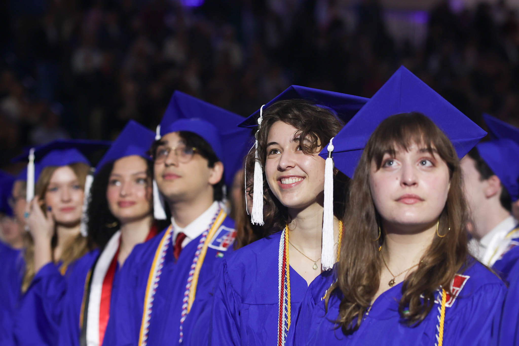 four graduates in Bender Arena during the Commencement Ceremony