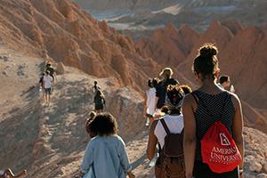 People with American University backpacks hiking a mountain