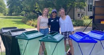 AU staff and students with trash sorting for compost, recycling, and trash.