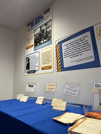 100 Years Undergrad Exhibit display posters and items on table