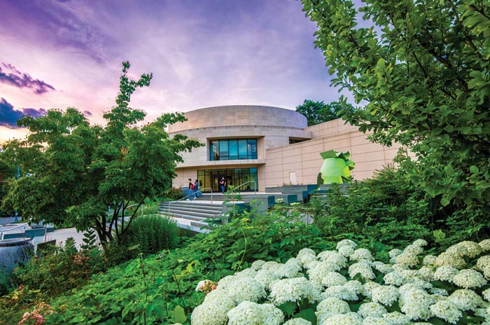 Katzen Arts Center surrounded by greenery at dusk