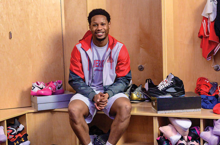 Colin Small, surrounded by sneakers in the AU locker room