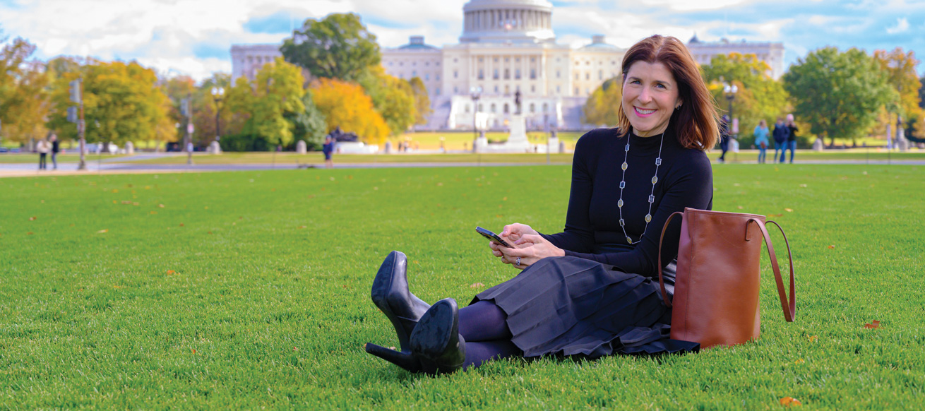 Amy Dacey sitting on the grass on the National Mall
