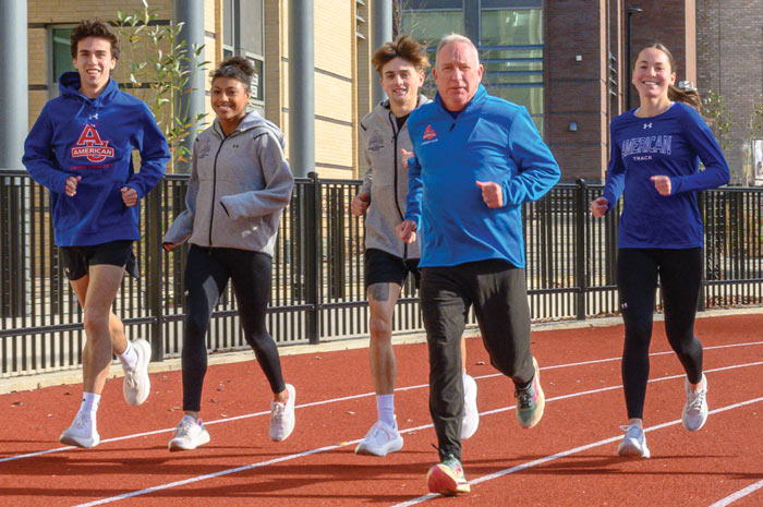 SPA lecturer Kevin Boyle runs the track with AU students