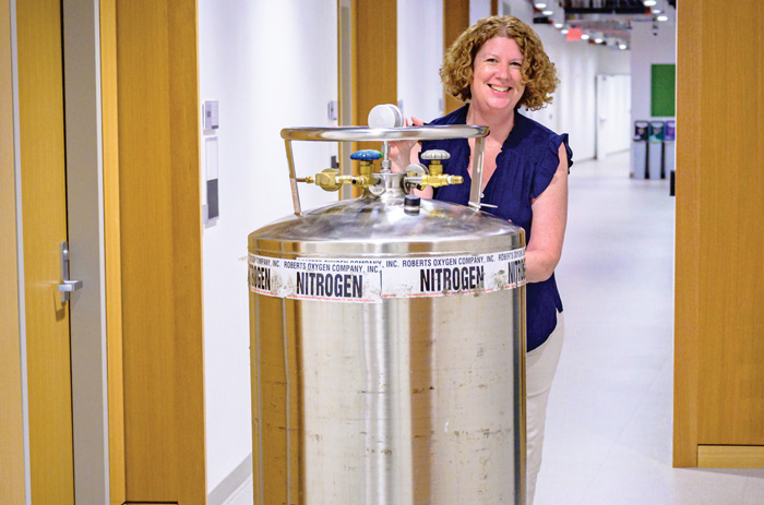 Bernadette Storey-Laubach pushes a nitrogen tank through the Hall of Science