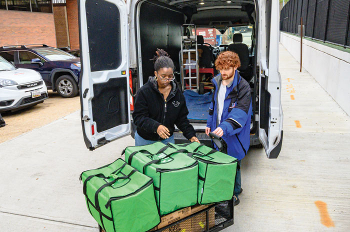 AU students and staff deliver food to a community partner