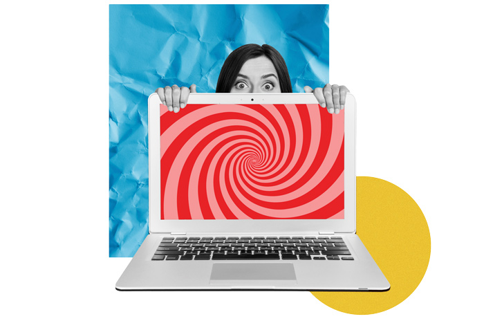 woman sitting wide-eyed behind a computer screen with swirling colors