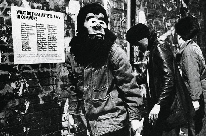 photo of Guerrilla Girls wheat-pasting posters on the streets of New York City