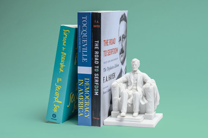 Stack of classic texts with a statue of Abraham Lincoln