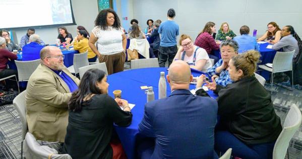 AU faculty and staff sit at tables in Constitution Hall at an Office of Inclusive Excellence event. Photo by Jeff Watts.