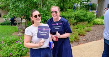 Two staff members smile for a photo on the quad during the community picnic. Photo by Jeff Watts