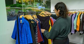 An AU graduate student peruses items in the FIT Closet. Photo by Jeff Watts.