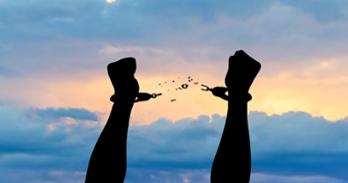 Person breaking free from handcuffs.