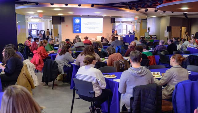 Individual presenting to room of people at tables
