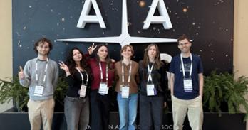 Dr. Johannes Lange at the American Astronomical Society conference with five physics students.