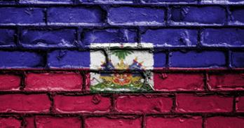 Haitian flag painted on a brick wall