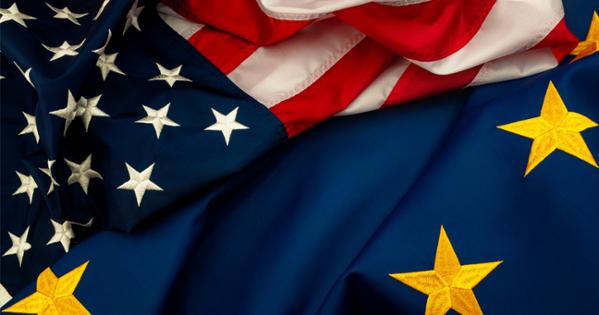A U.S. and European Union flag overlapping each other.