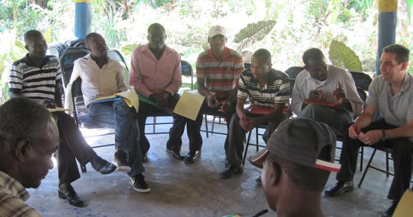 Professor Anthony Wanis-St. John speaks with a group of men in Haiti