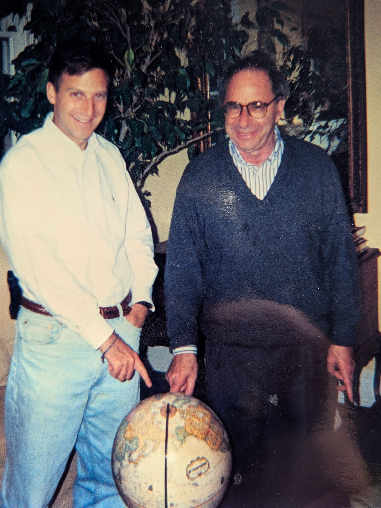 Carl Levan and Marc Raskin with a globe
