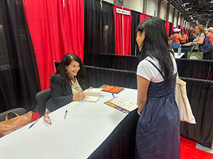 Author Ada Limon signs a book for a student