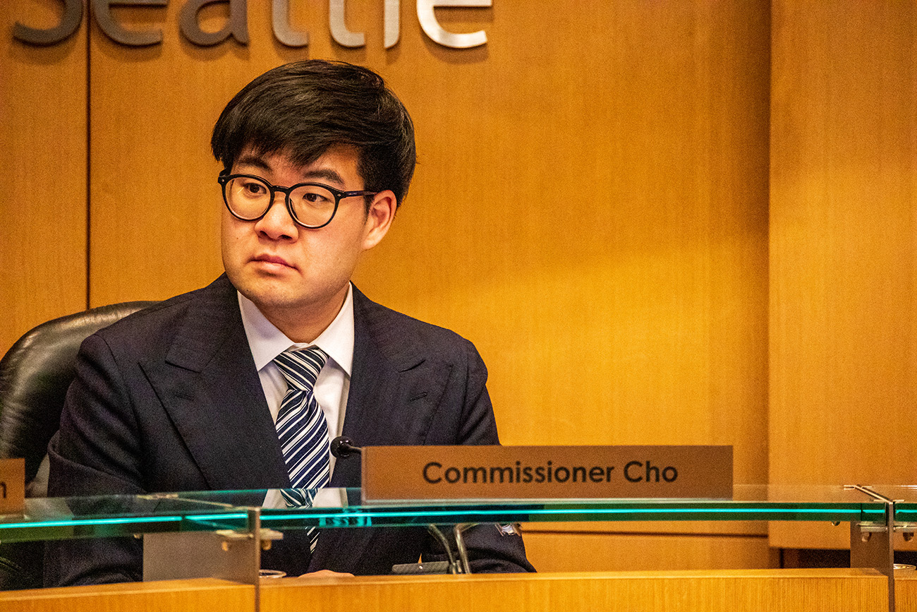 Commissioner Sam Cho sits at a desk