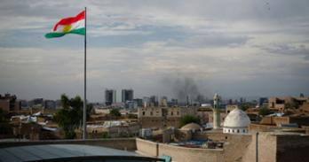 Kurdish flag flying over a building.