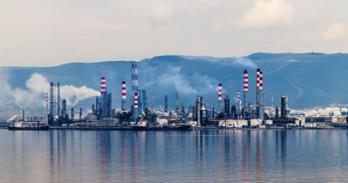 Photo of a oil refinery on the water.