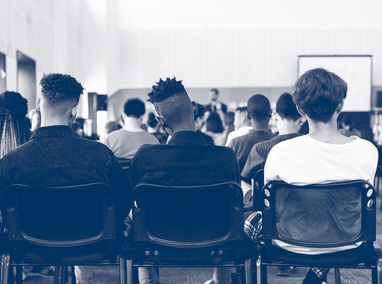 Three students learning in a classroom