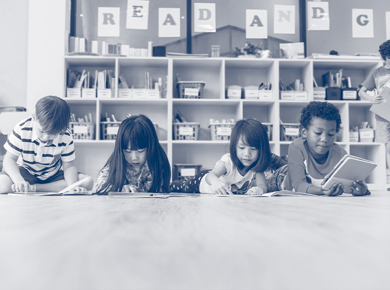 Young students reading on the floor