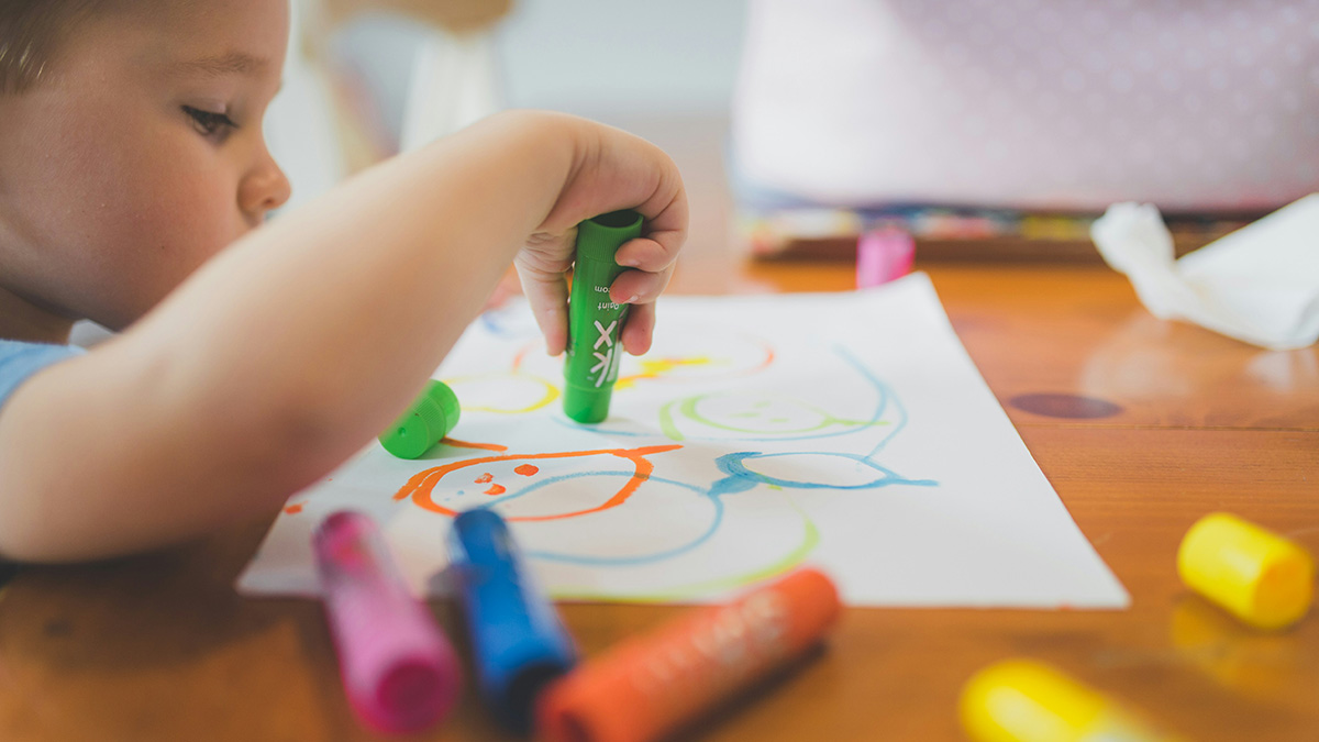 Child draws with a marker
